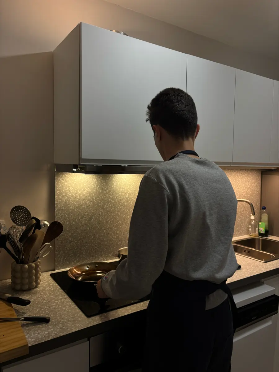 Greg cooking at the stove